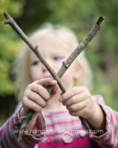 Making the letter X out of two tree branches. 