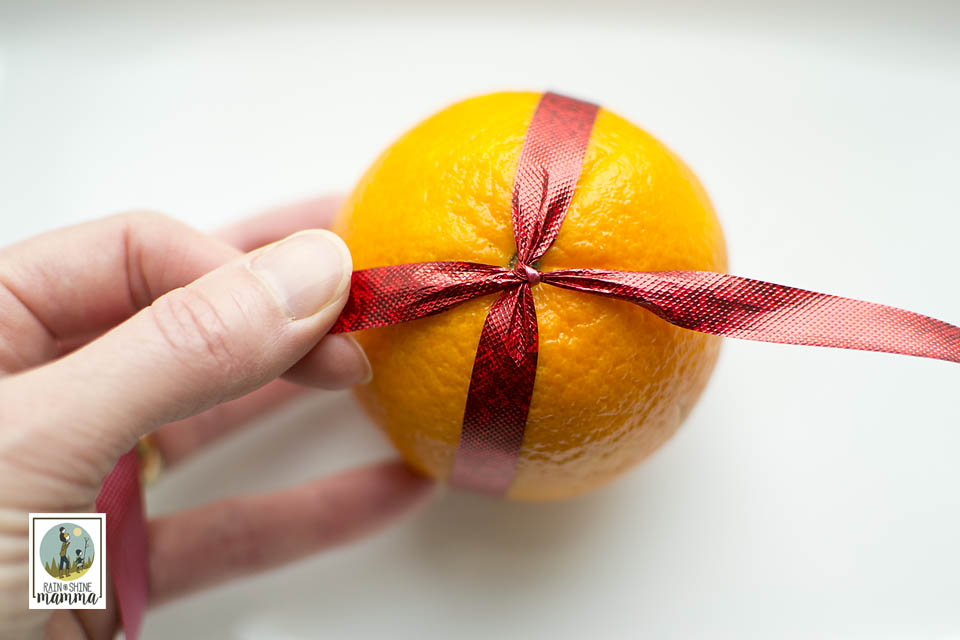 How to Make Pomander Christmas Oranges. Tie the ribbon on the orange first. Rain or Shine Mamma.