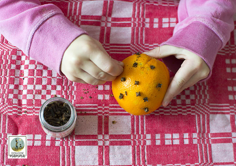 How to Make Pomander Oranges. Push the cloves into the orange. Rain or Shine Mamma.